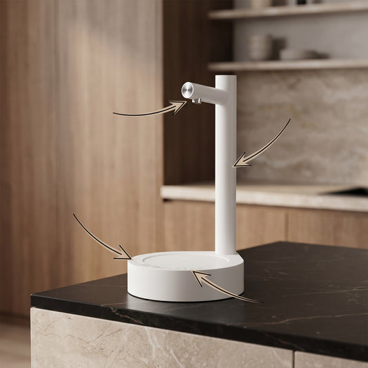 Automatic soap dispenser with a sleek minimalist design placed on a kitchen countertop beside a sink.