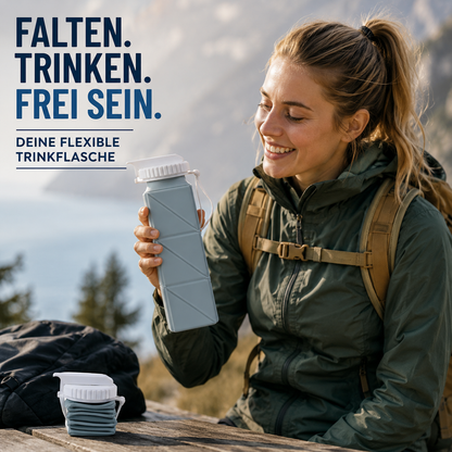 Person nutzt eine faltbare Silikon-Trinkflasche während einer Wanderpause in den Bergen.